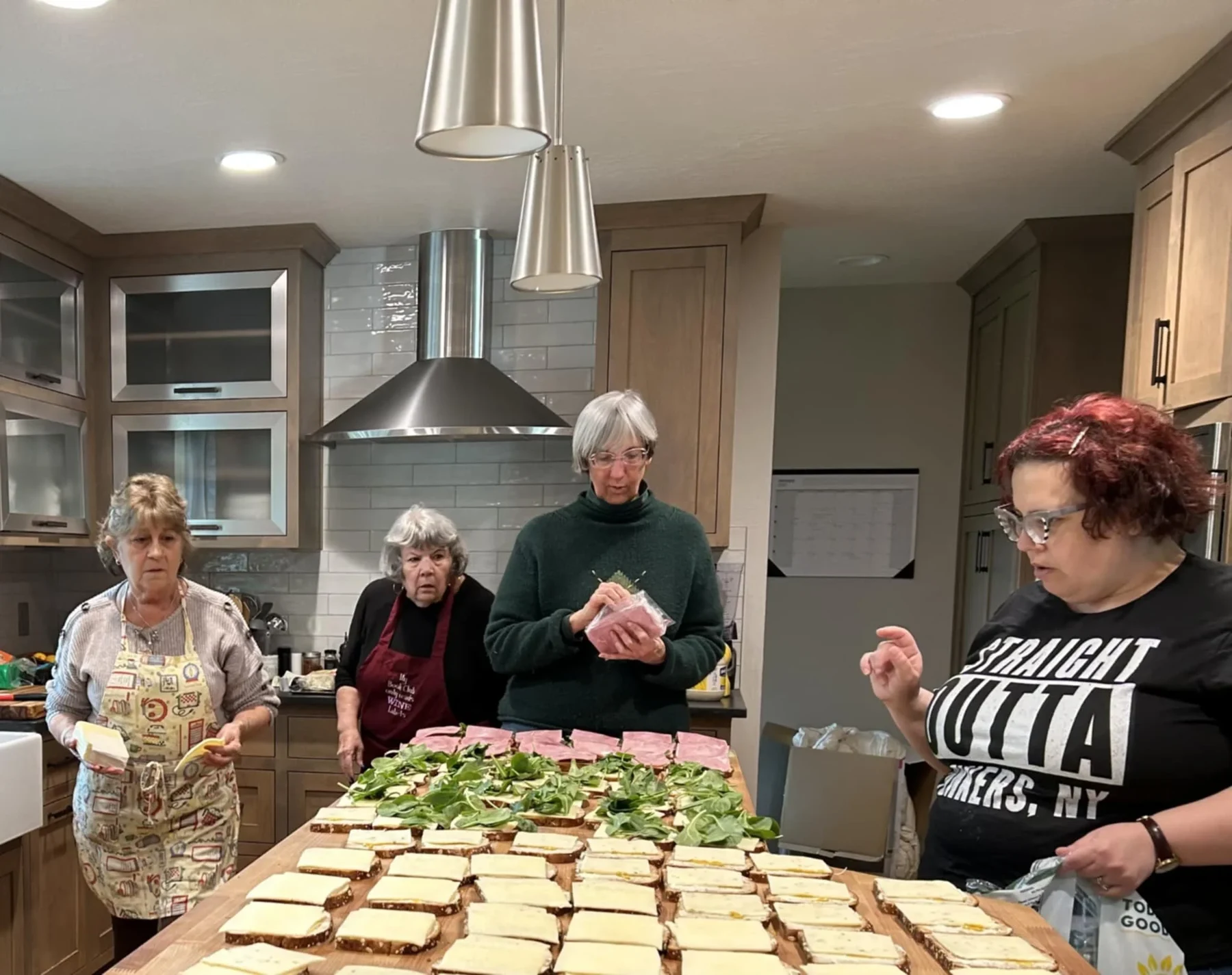 Volunteers preparing sandwiches together.