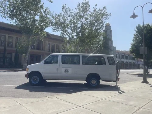 A van parked outside with outreach supplies.